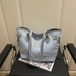Light blue large capacity tote bag featuring quilted texture and pink embroidered bows