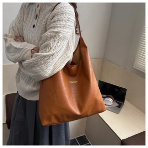 Brown vintage oil wax leather tote bag shown in a stylish daily commuting scene