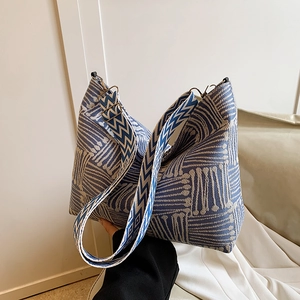 Large blue and beige checkered canvas tote bag with a wide woven shoulder strap