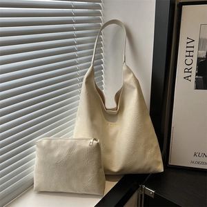 Retro cream white oil wax leather tote bag set with FASHION lettering in natural window light