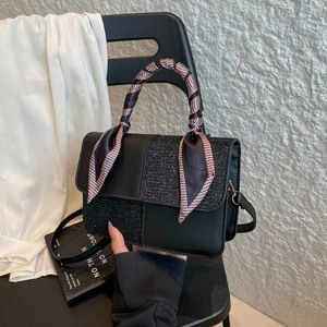 Elegant black faux leather crossbody bag with glitter panels and silk scarf handle