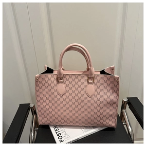 Detailed shot of pink tote bag with M-pattern print on elegant metal chair