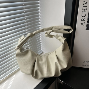 Minimalist cream white dumpling hobo bag with pleated texture and knot handle detail
