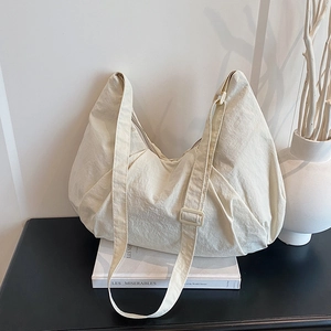 Large capacity off-white nylon tote bag with pleated texture and adjustable strap
