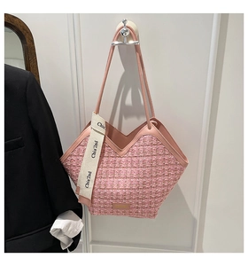 Detail of pink tweed tote bag with V-shaped opening and decorative logo ribbon