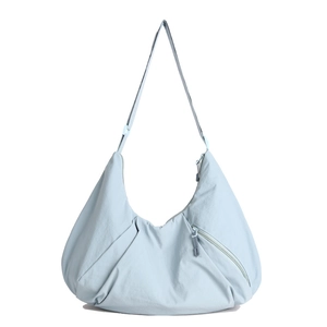 Light blue-grey nylon crescent bag with adjustable strap and front zipper pocket
