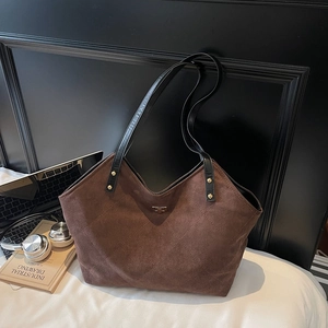 Brown large capacity tote bag in faux suede with quilted texture and black top handles