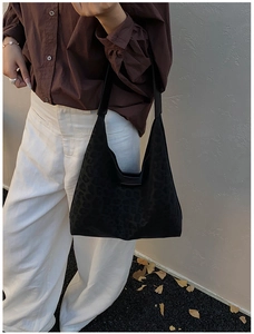 Chic black leopard print tote bag with a textured finish styled for autumn office wear