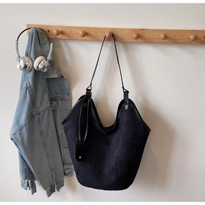 Large capacity black suede tote bag with long leather strap and contrast charm detail