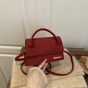 French minimalist red suede small square crossbody bag with gold logo on knit fabric