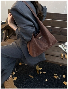 Close-up of leopard print tote bag with dark brown leather straps in autumn outdoor setting
