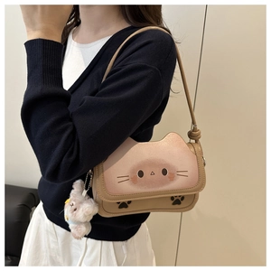 Detail of cute khaki cat handbag featuring gradient pink flap and plush sheep pendant
