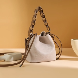 French design cream and brown bucket bag with litchi grain leather and chain handle