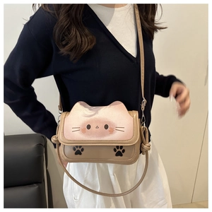 Detail of cute cat-themed crossbody bag with adjustable strap and ear-shaped flap