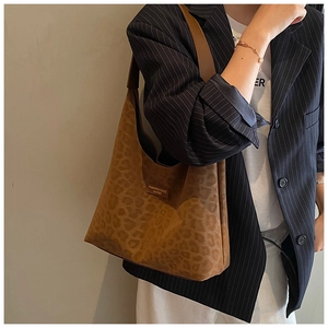 Detailed view of brown leopard print hobo tote bag featuring a leather fashion logo tag