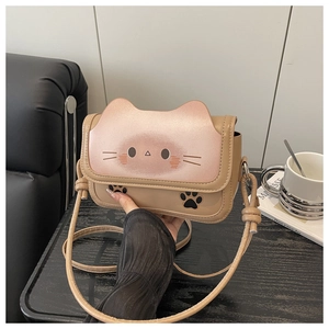 Detailed close-up of a cute cartoon cat crossbody bag with pink ears and paw prints