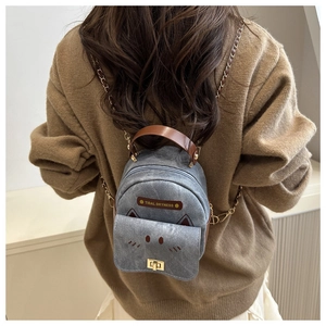 Detailed back view of a mini gray cat-themed backpack with chain straps and gold lock