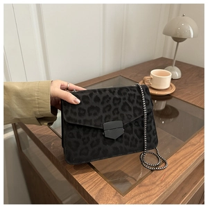 Détail du sac léopard avec bandoulière chaîne gris foncé et fermoir géométrique