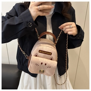 Detail of pink cat-shaped mini backpack with cat ears and metal chain shoulder strap