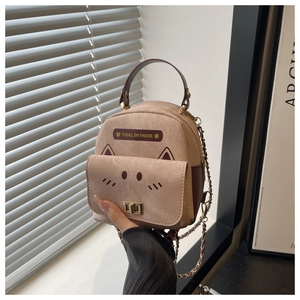 Detail view of pink cat-shaped mini bag with metal twist lock and chain strap