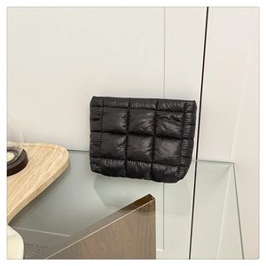 Close-up of black quilted bubble handbag featuring professional square texture and padded fabric