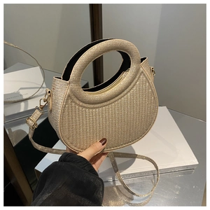 Detail of glitter champagne gold crescent handbag with circular hollow handle and strap