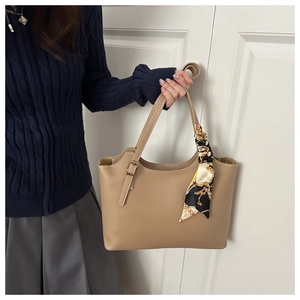 Elegant khaki tote bag with printed silk scarf detail styled for professional daily commute