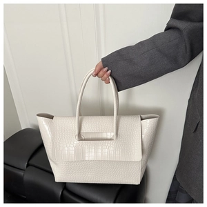 Close-up of cream crocodile pattern tote bag with double top handles for daily commute