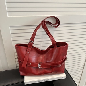 Retro dark red leather tote bag with decorative buckle and adjustable shoulder strap