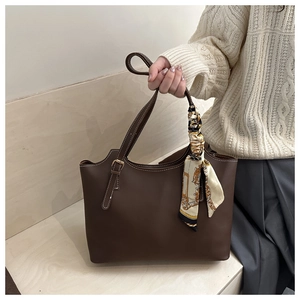 Deep brown leather tote bag detail with vintage silk scarf and silver metal hardware