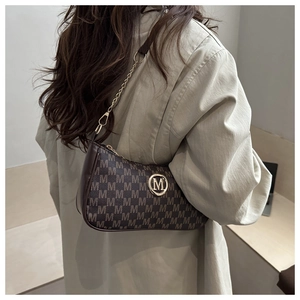 Dettaglio della borsa sottobraccio vintage marrone con monogramma M e logo in metallo oro