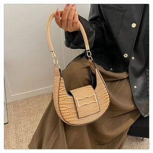 Detail of light brown crocodile-embossed PU leather hobo bag with gold buckle