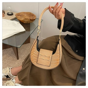 Detailed close-up of light brown stone texture PU leather half-moon shoulder bag with gold buckle