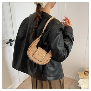 Detail of beige stone texture PU leather underarm bag with gold metal buckle decoration