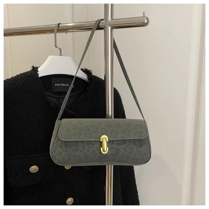 Detail of dark green leopard print suede underarm bag with gold metal cylinder lock