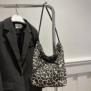 Fashionable leopard print tote bag with bow detail and black shoulder strap for winter 2025