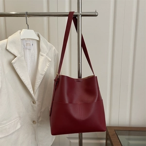 Deep red vintage leather bucket bag with adjustable strap for women in autumn fashion