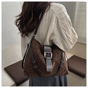 Detail of leopard print hobo tote bag in brown suede with adjustable side buckle straps
