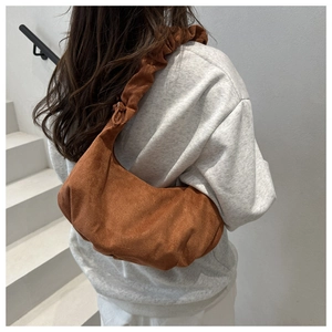 Brown pleated suede hobo bag on shoulder, minimalist urban style back view detail