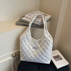 Quilted silver metallic tote bag with rhombic stitching and Fashion Instinct patch