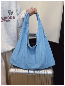 Close-up of light blue large capacity tote bag with adjustable drawstring detail