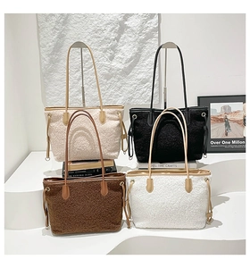 Detail of four colorful shearling tote bags with leather trim and drawstring accents