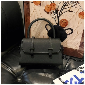 Detail of black Saffiano leather trapezoid bag with dual straps and gunmetal chain strap