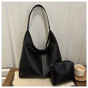 Detail view of the black soft leather tote bag set including a small zipper pouch