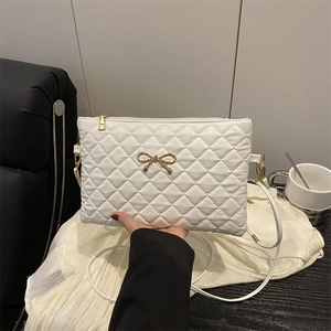 Sac à bandoulière matelassé blanc avec nœud doré et motif à losanges élégant
