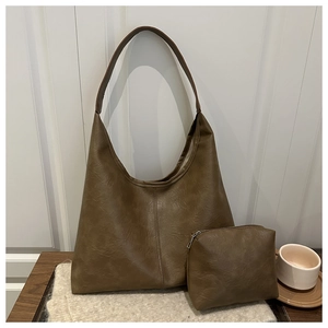 Detail of vintage brown soft leather tote bag with a matching small zipper pouch