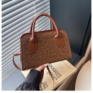 Detailed view of brown leopard print tote bag with matte suede texture and leather handles