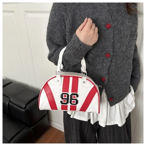Detail of white sporty bowling handbag with red stripes and number 96 patch embroidery