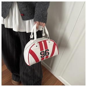 Detail of white sporty bowling handbag with red stripes and vintage 96 embroidery patch