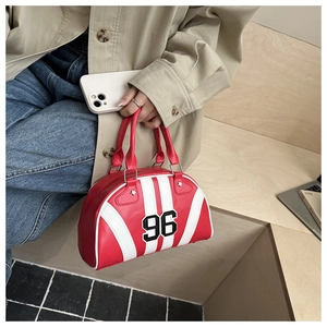 Detail of red sports bowling bag featuring contrast white stripes and number 96 patch